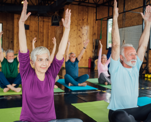 Aging adults in yoga class to practice healthy active living